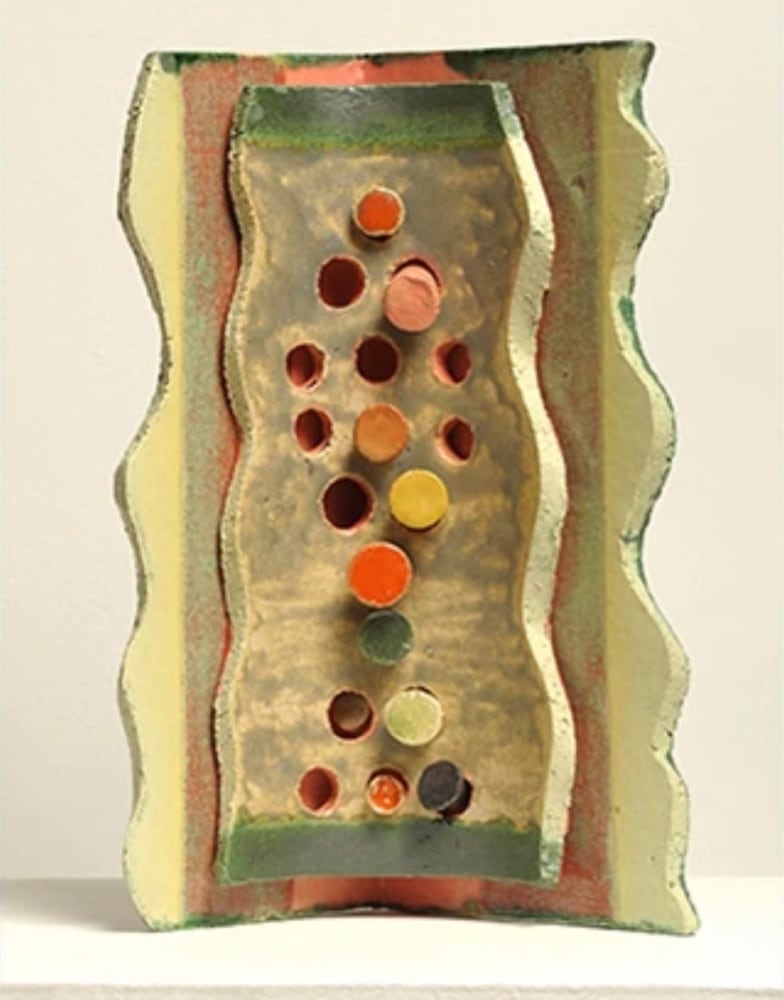 ceramic collage with slabs and round small pieces glazed in green and orange