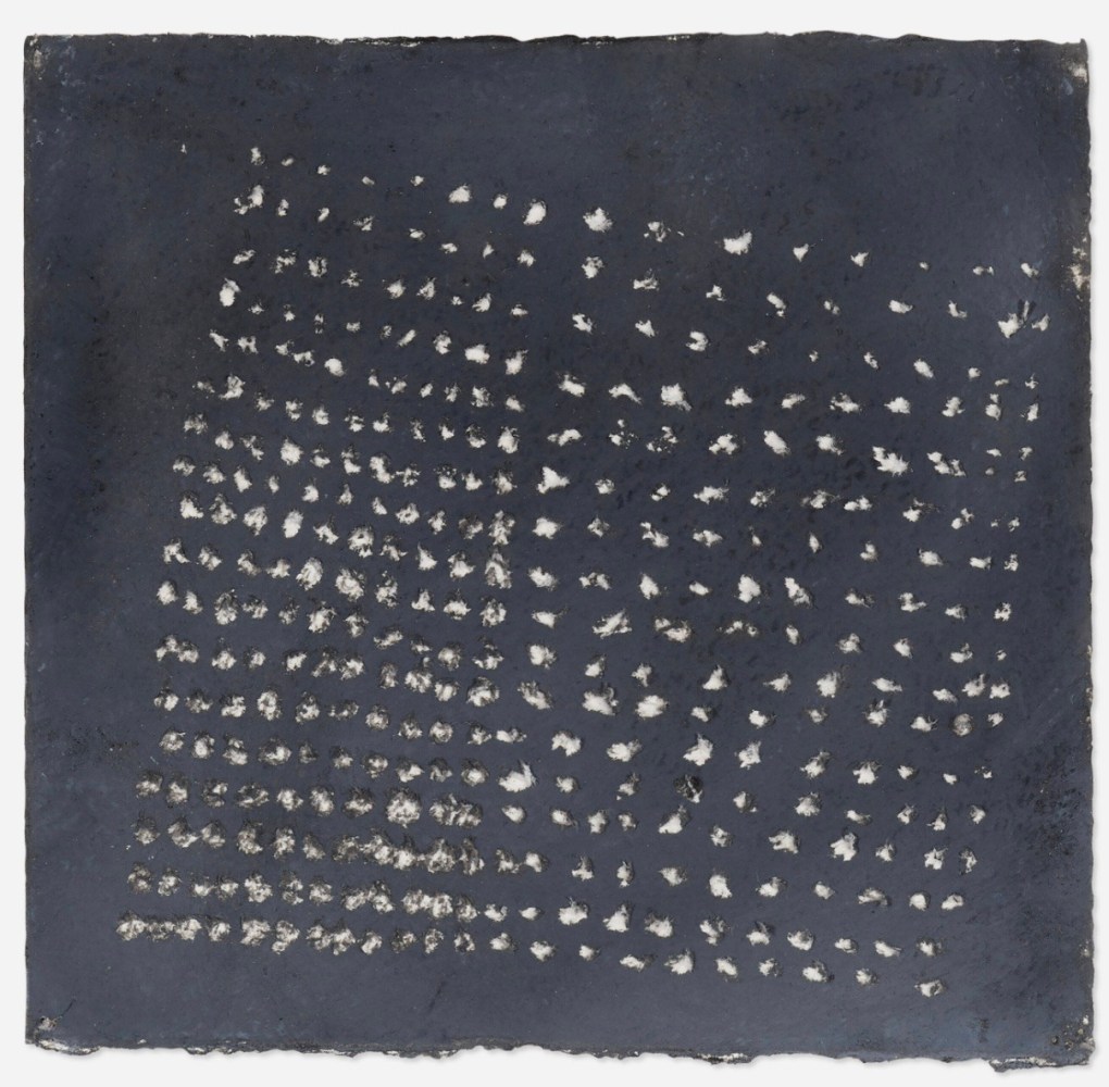 small sheet of watery black paper with white brushy dots