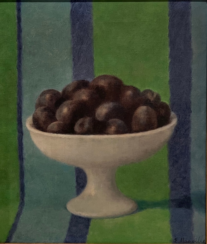 plums in a white dish against a blue and green striped backtroune