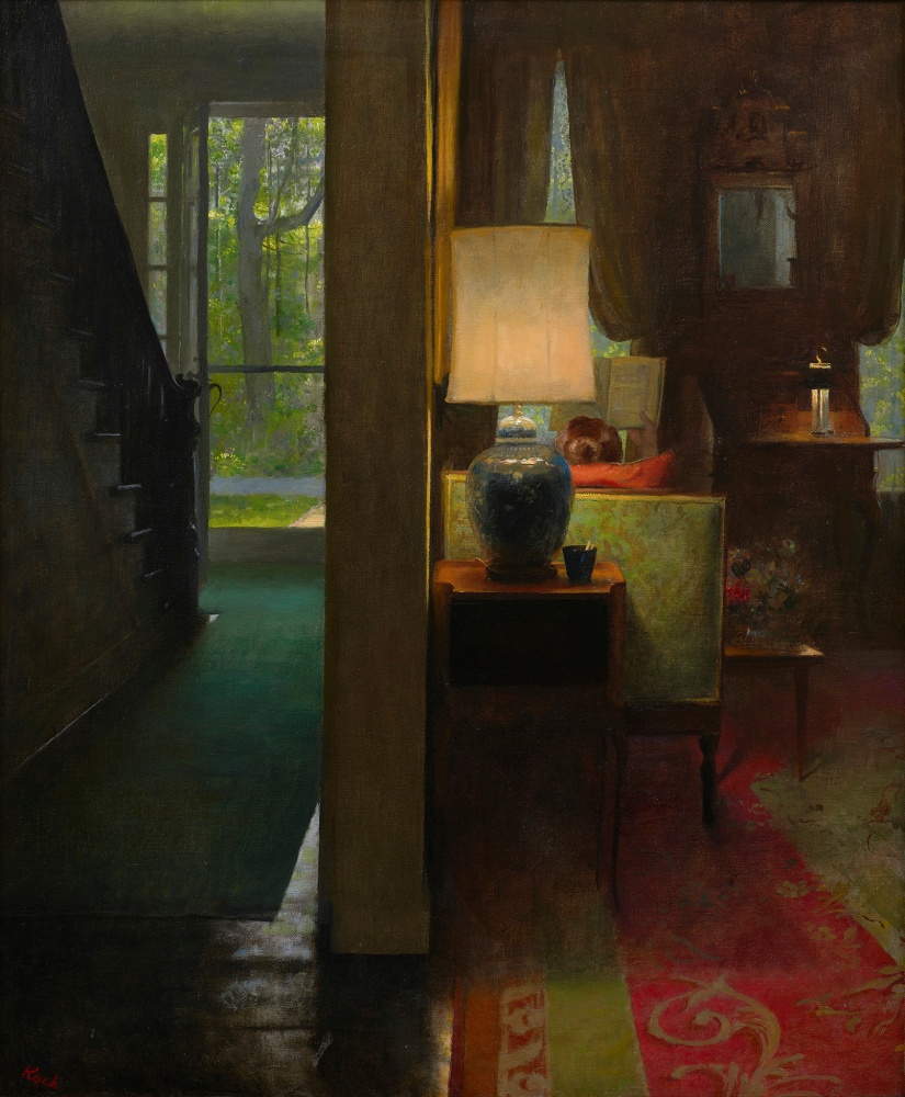 dark interior with a lamp in the center and the back of a head of a woman reading on the