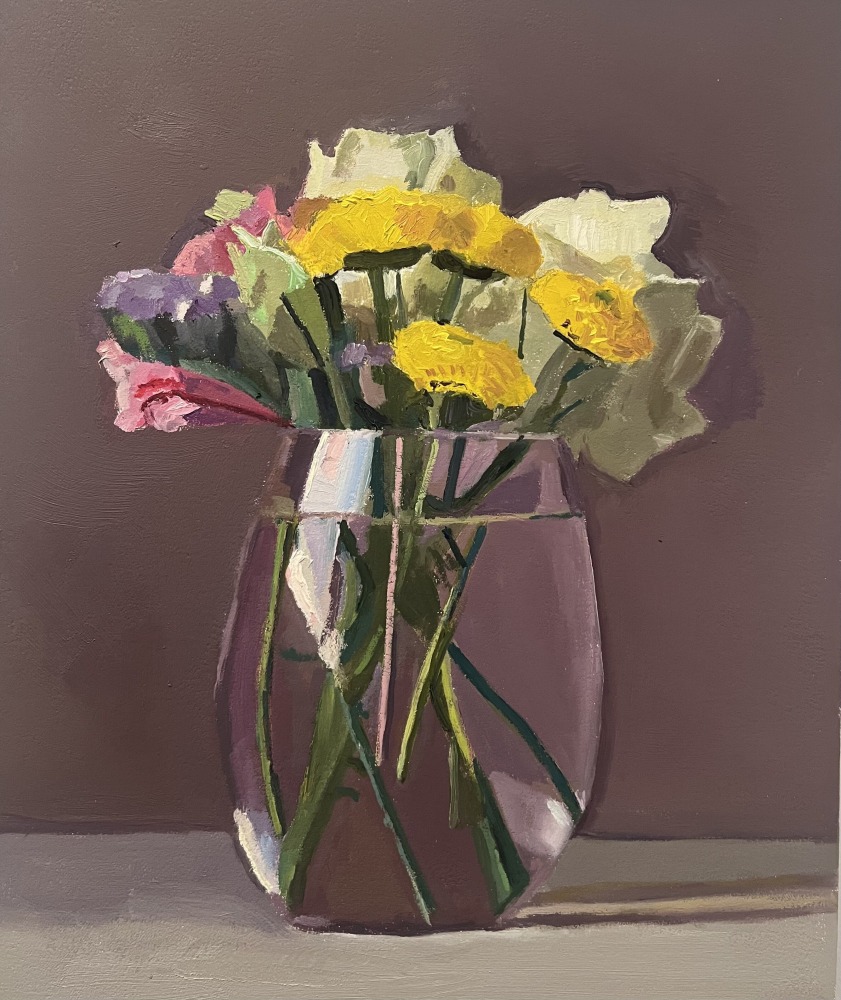 a bouquet including pink lisianthus in a glass vase