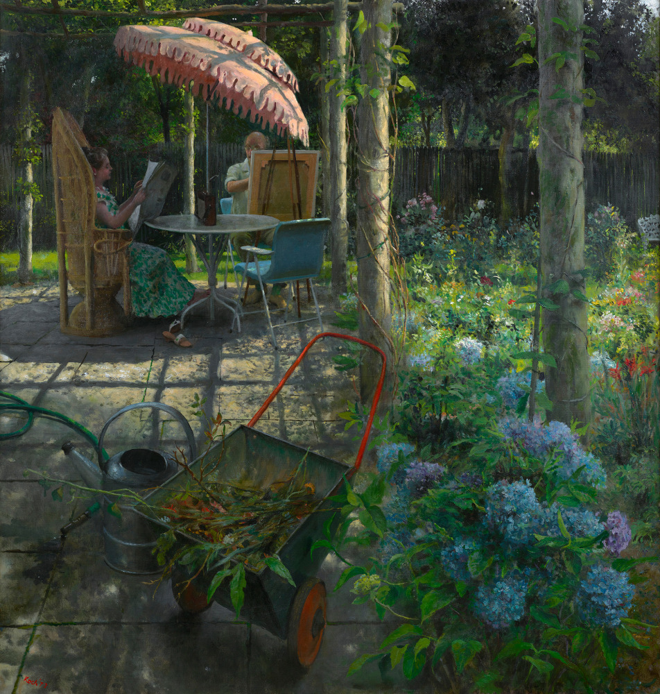 floral foreground with man and woman seated at table under an umbrella