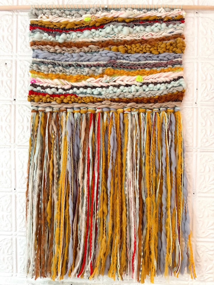 weaving in wool and cotton with long fringe
