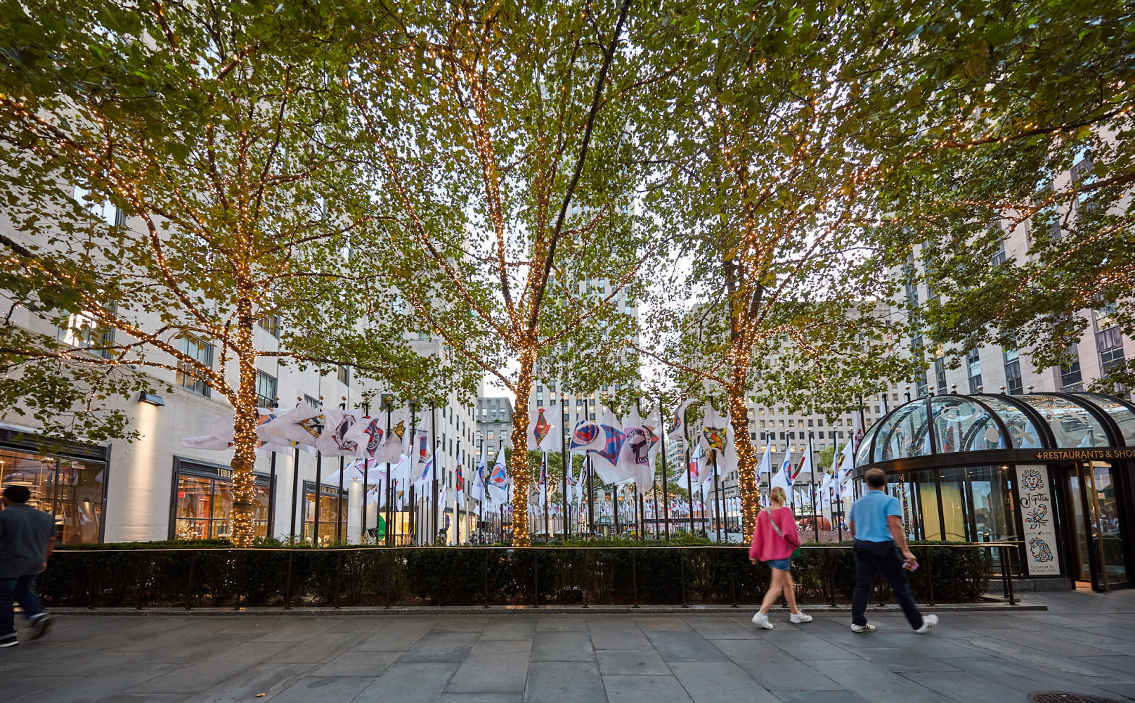 Installation view of flags featuring images from the Peace Paintings series (2003), Rockefeller Center, New York, 2023. Photo: Tom Powel Imaging; Artwork: &amp;copy; The Robert Indiana Legacy Initiative/Artists Rights Society (ARS), NY
