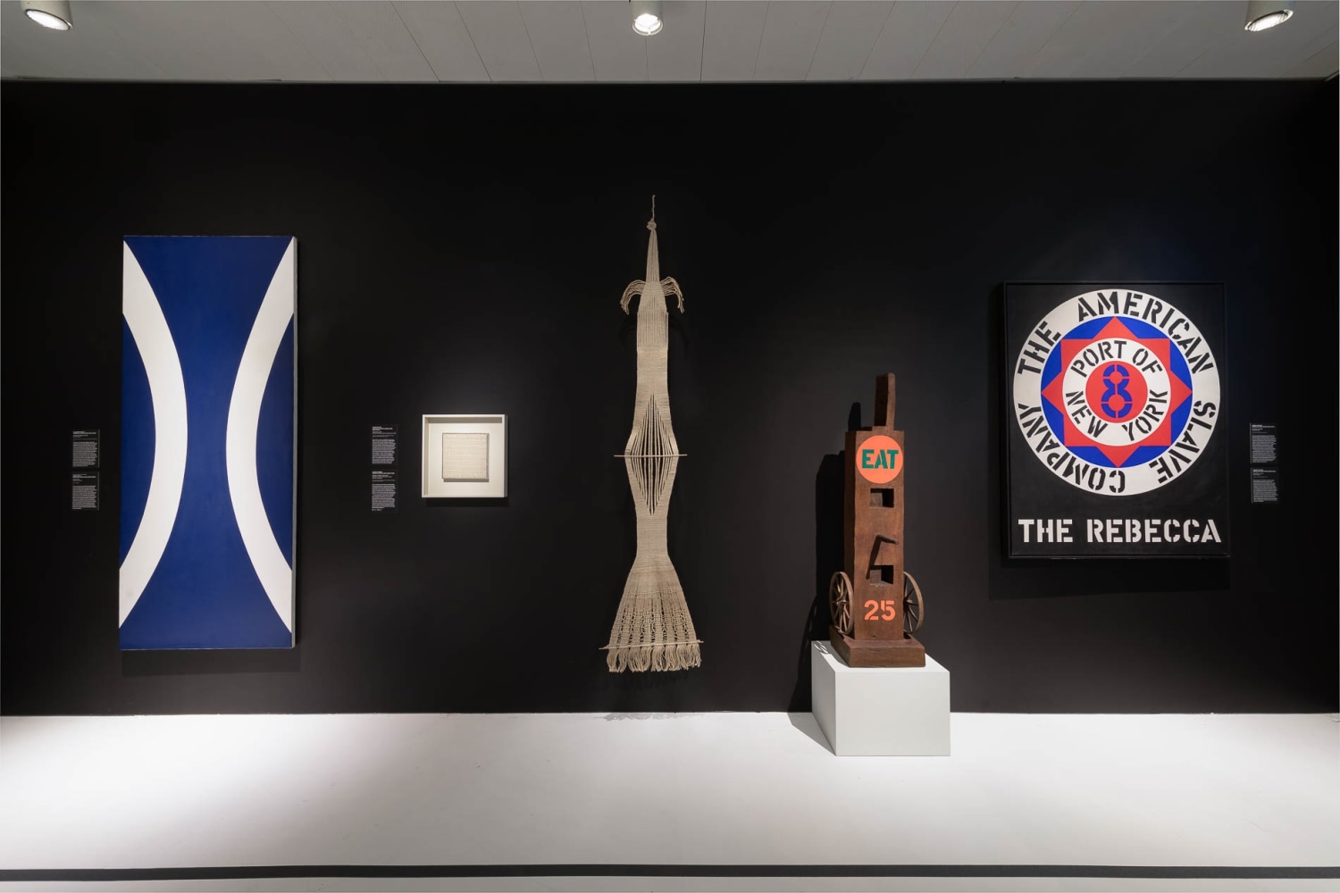 Installation view of New York: 1962-1964 at the Jewish Museum featuring five works, including Indiana's bronze sculpture Eat and the painting The Rebecca