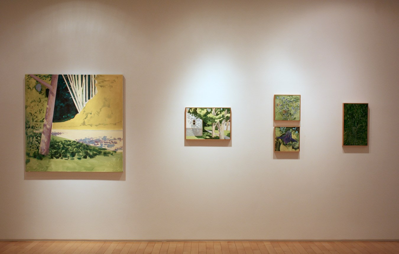 Photograph showing a view of an exhibition space, with five paintings hanging on a white wall