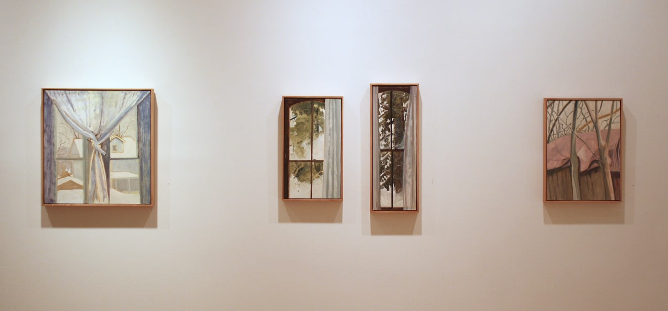 Photograph showing a view of an exhibition, with four small framed paintings hanging on a white wall