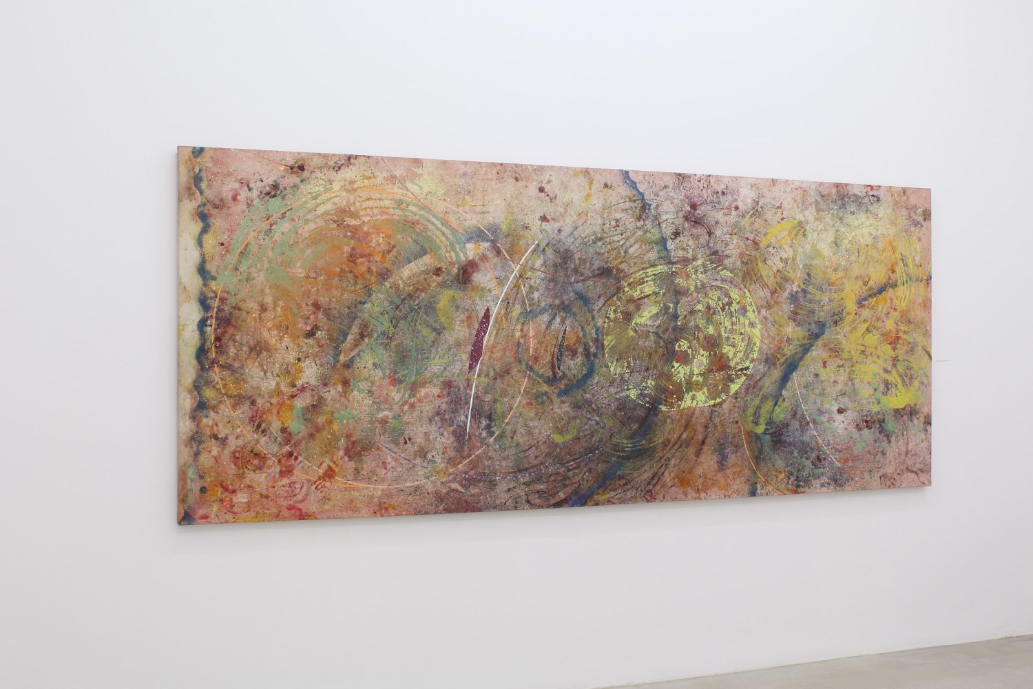 Photograph showing a view of an exhibition space, with one large painting hung on a white wall