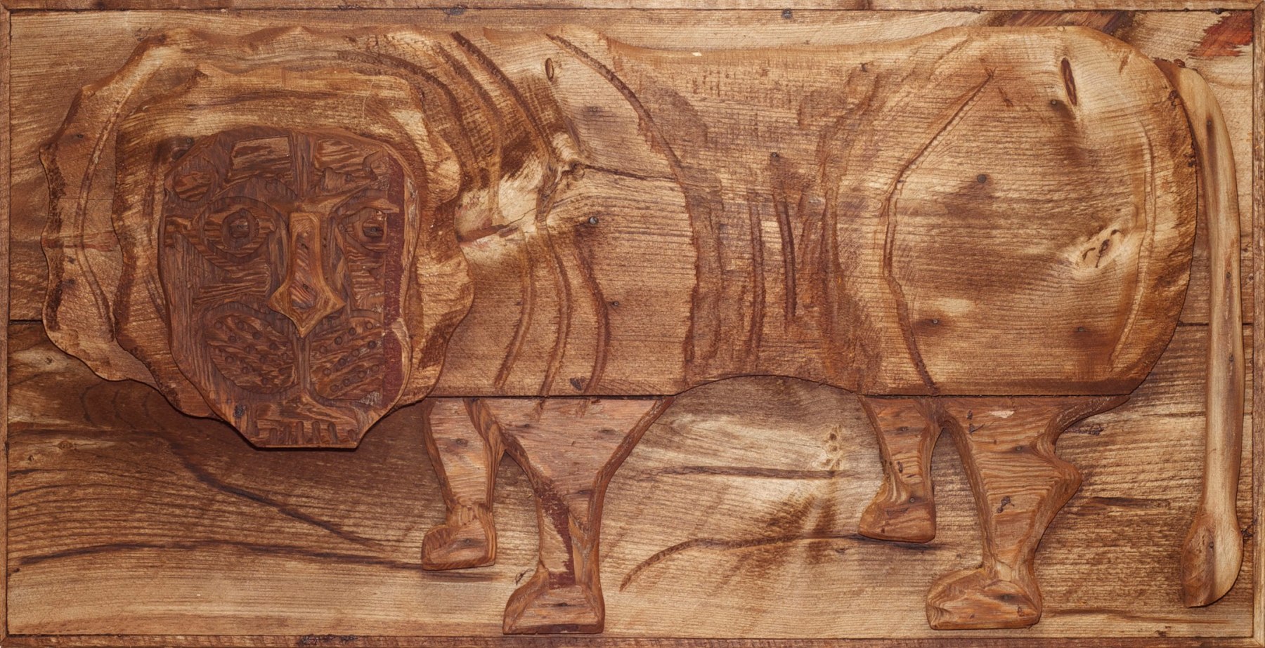Wooden relief sculpture of an abstracted lion