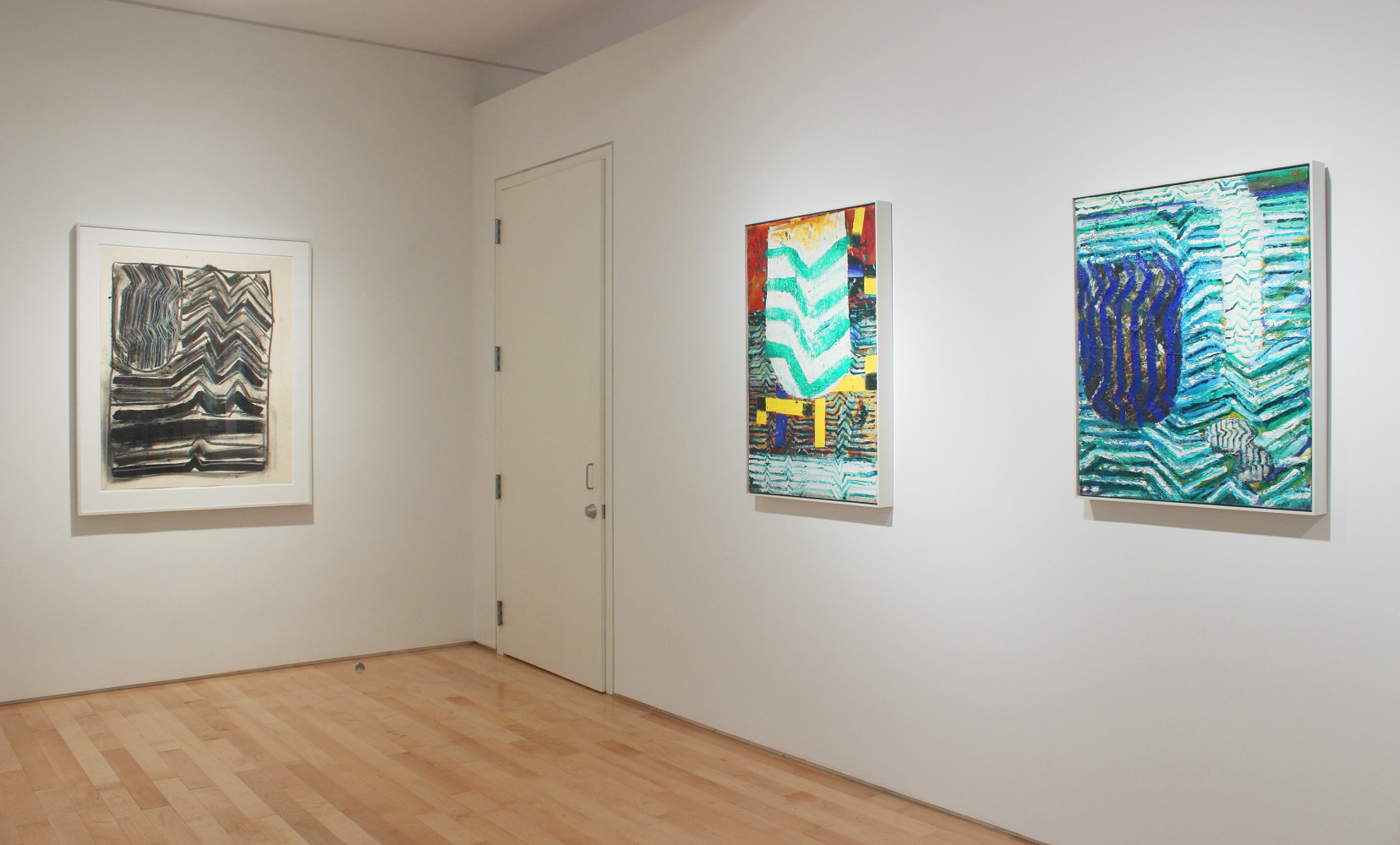 Photograph showing a corner view of an exhibition space, two paintings and one framed drawing hanging on white walls