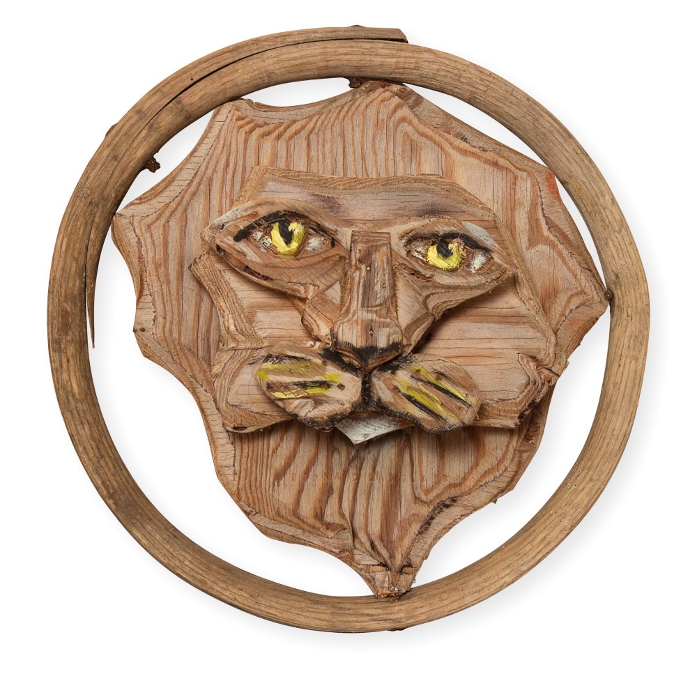 Wall-hanging, partially-painted wood sculpture of the head of a lion inside a wooden hoop