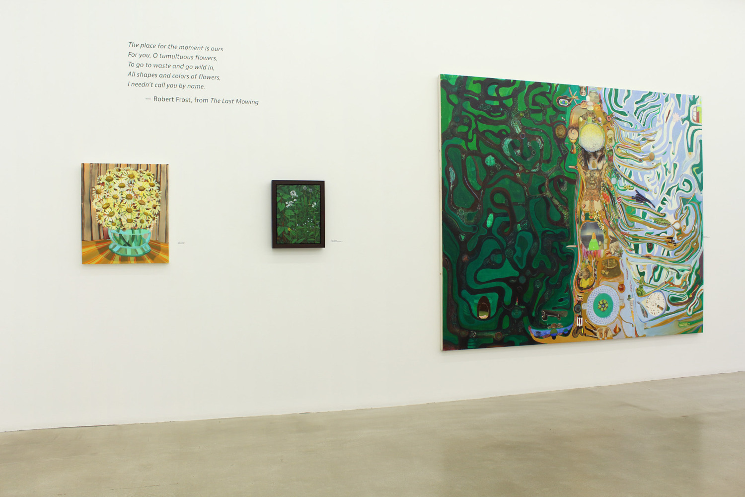 Photograph of a detail view of an exhibition with three paintings hung on a white wall