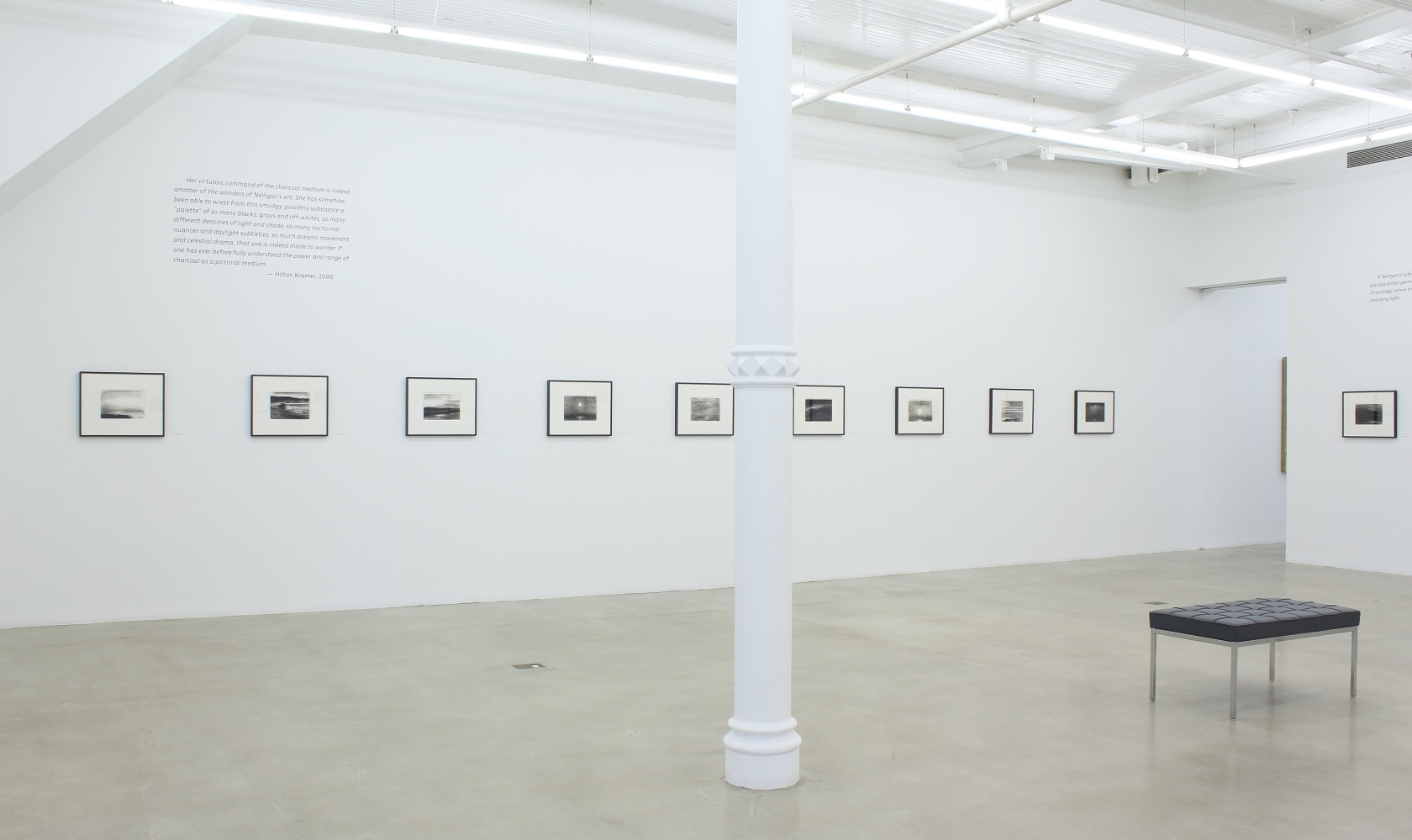 Photograph of ten framed drawings in a white gallery exhibition space