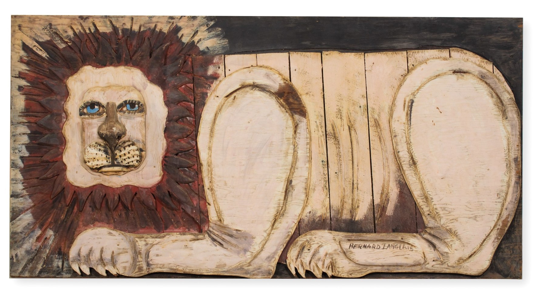 Painted wall-hanging wooden sculpture of an abstracted lion figure