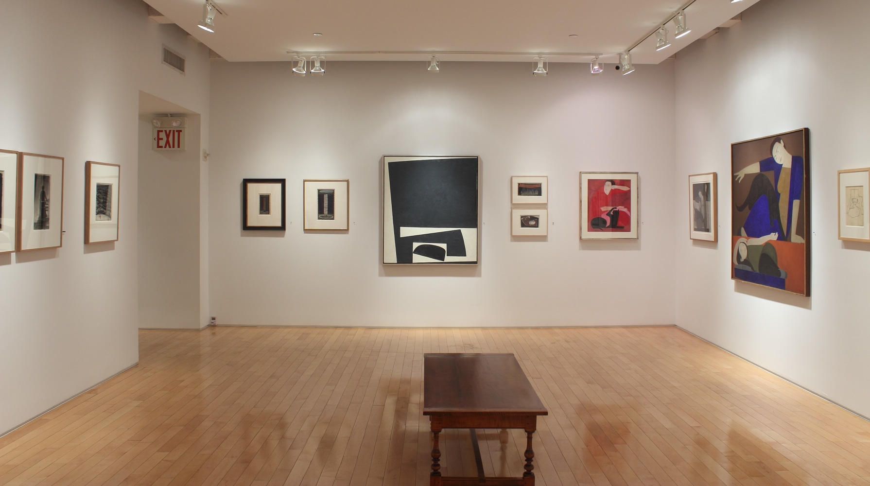 Photograph showing a view of an exhibition space with two paintings and ten smaller framed drawings hanging on white walls
