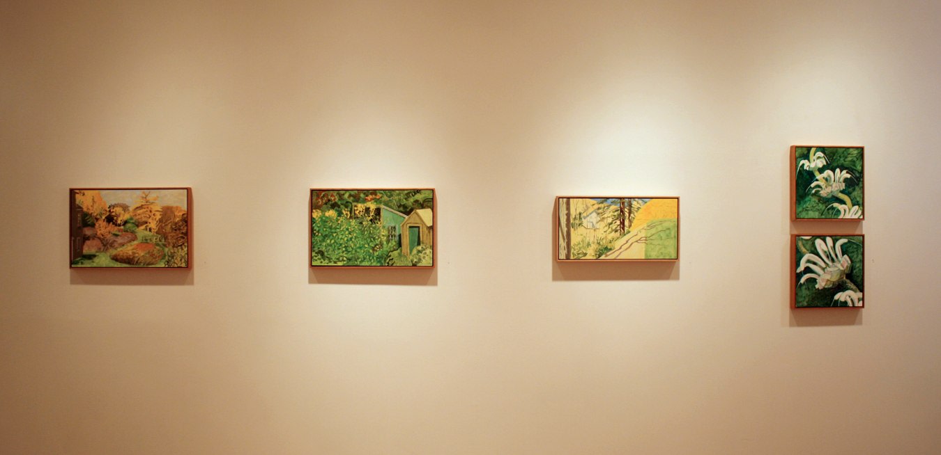 Photograph showing a view of an exhibition, with five small framed paintings hanging on a white wall