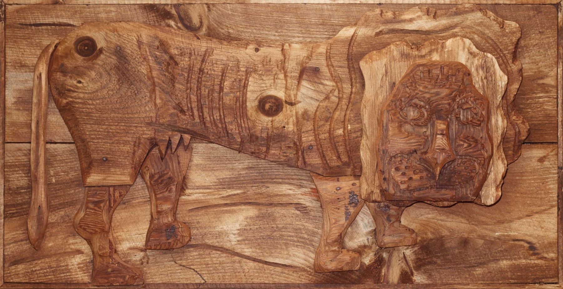 Wall-hanging wood sculpture of an abstract lion figure