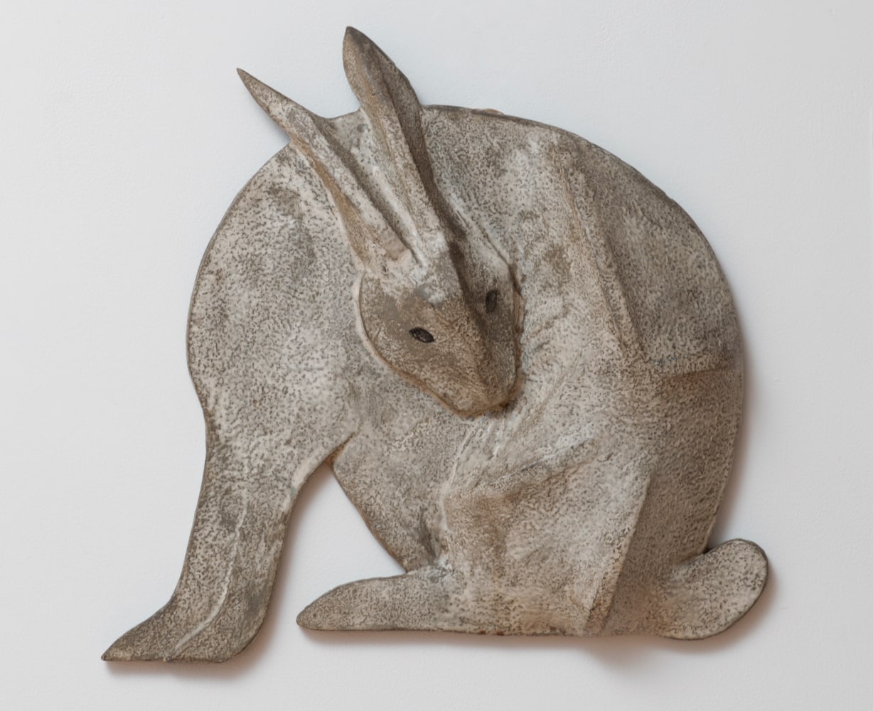 Wall-hanging sculpture of a grey rabbit