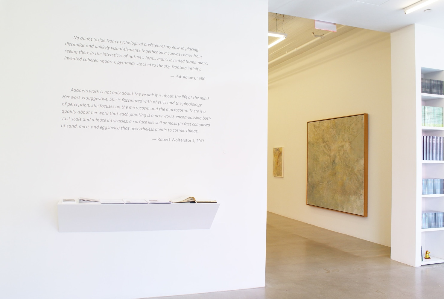 Photograph showing a view of an exhibition, including a wall with information regarding the exhibition