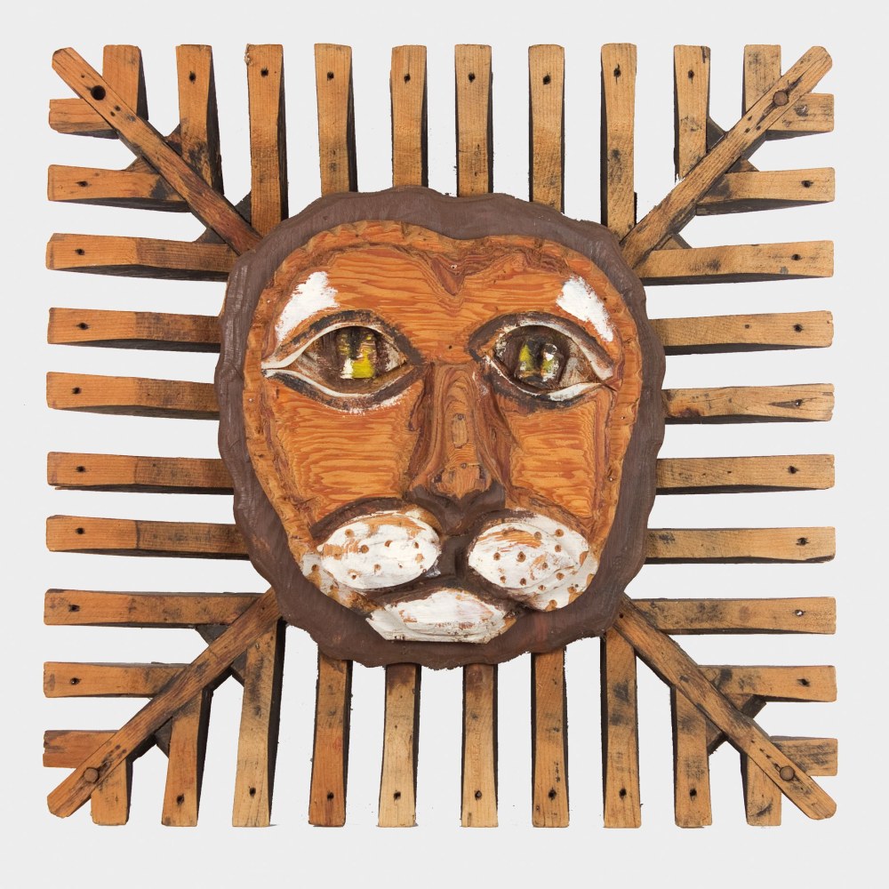 Wooden sculpture of an abstracted lion head