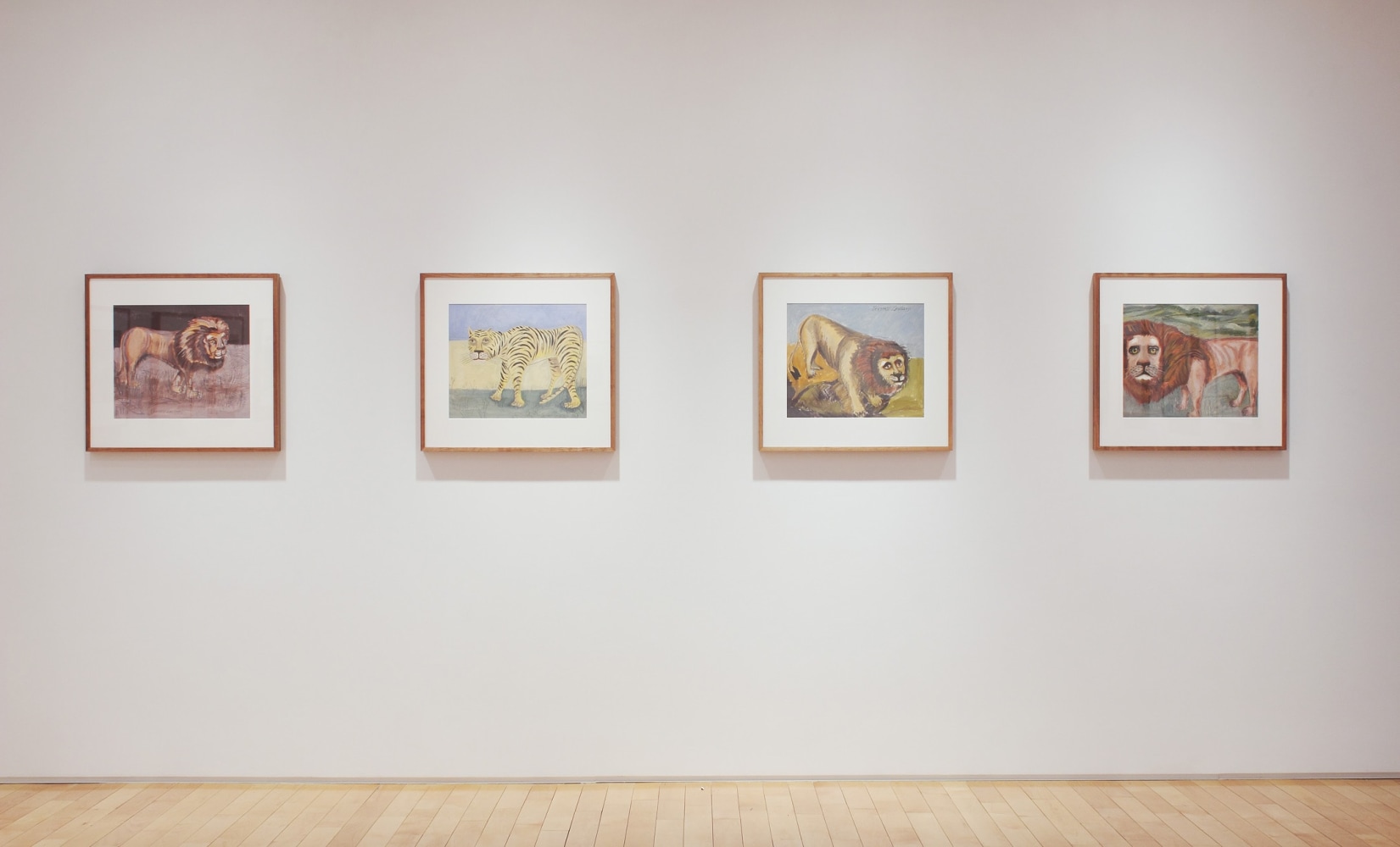 Photograph showing a view of an exhibition space, with four framed drawings hanging on a white wall