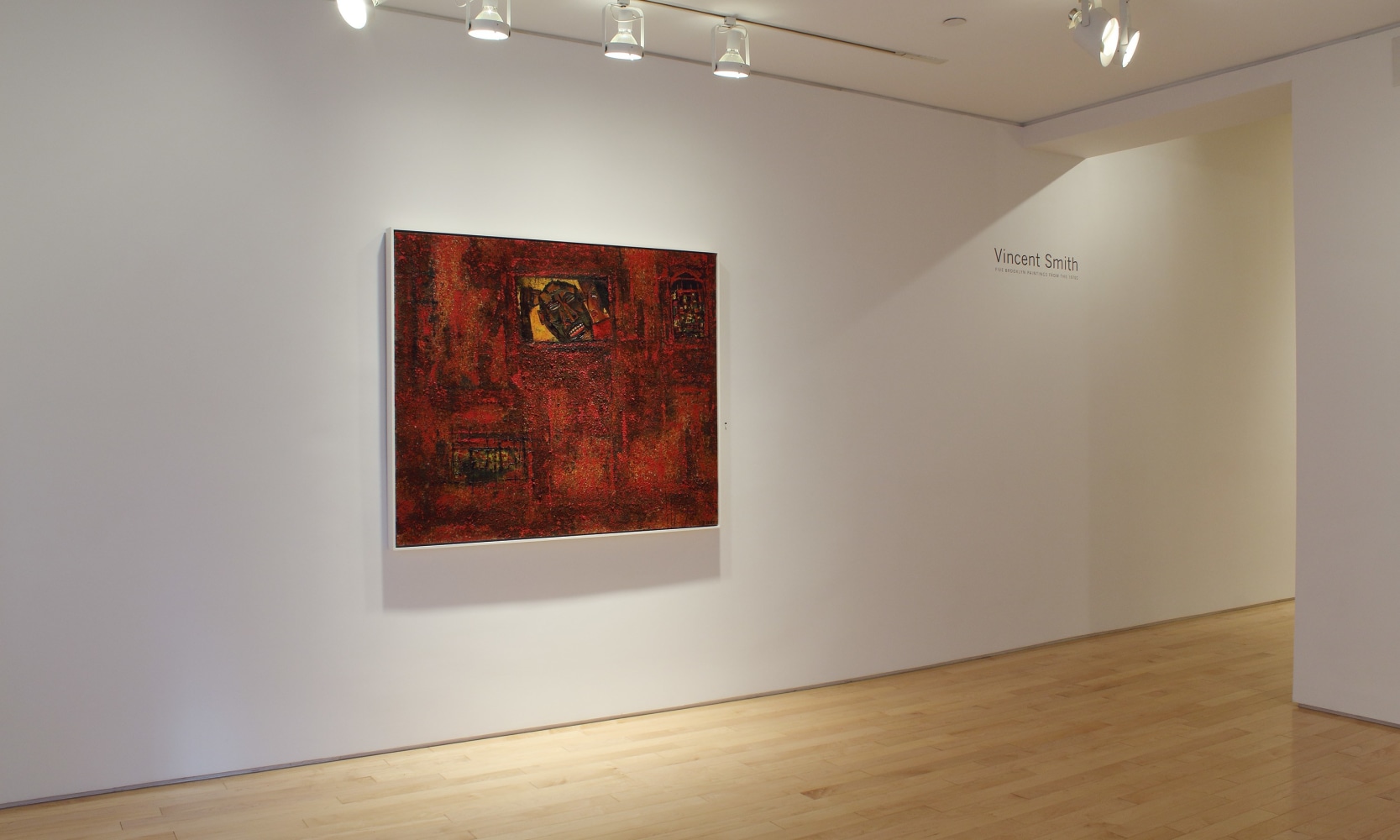 Photograph showing a view of an exhibition space, with one painting hung on a white wall
