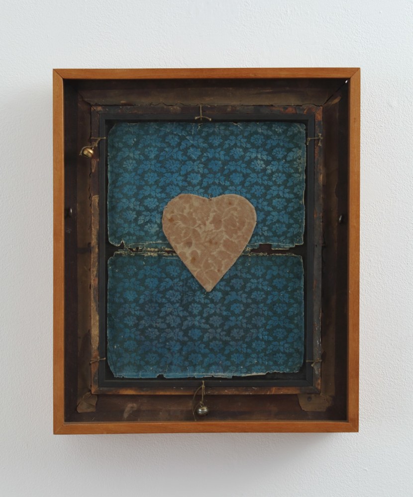 Framed collage made from two pieces of patterned paper and a heart in the center cut from patterned paper