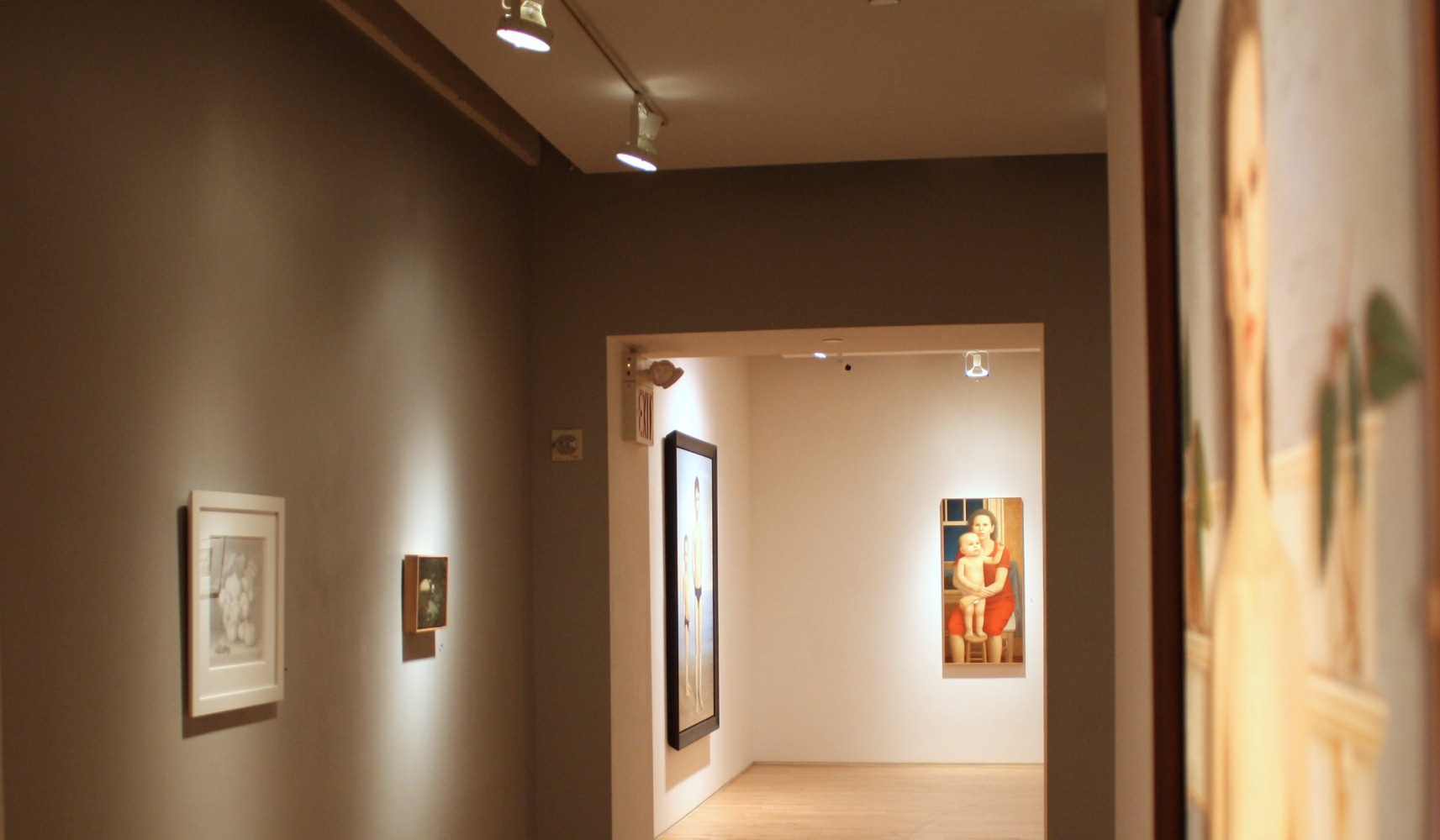 Photograph showing a view of an exhibition, with four framed works hanging on the walls
