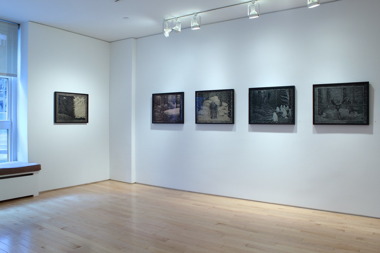 Photograph showing a corner view of an exhibition space with five drawings hanging on white walls