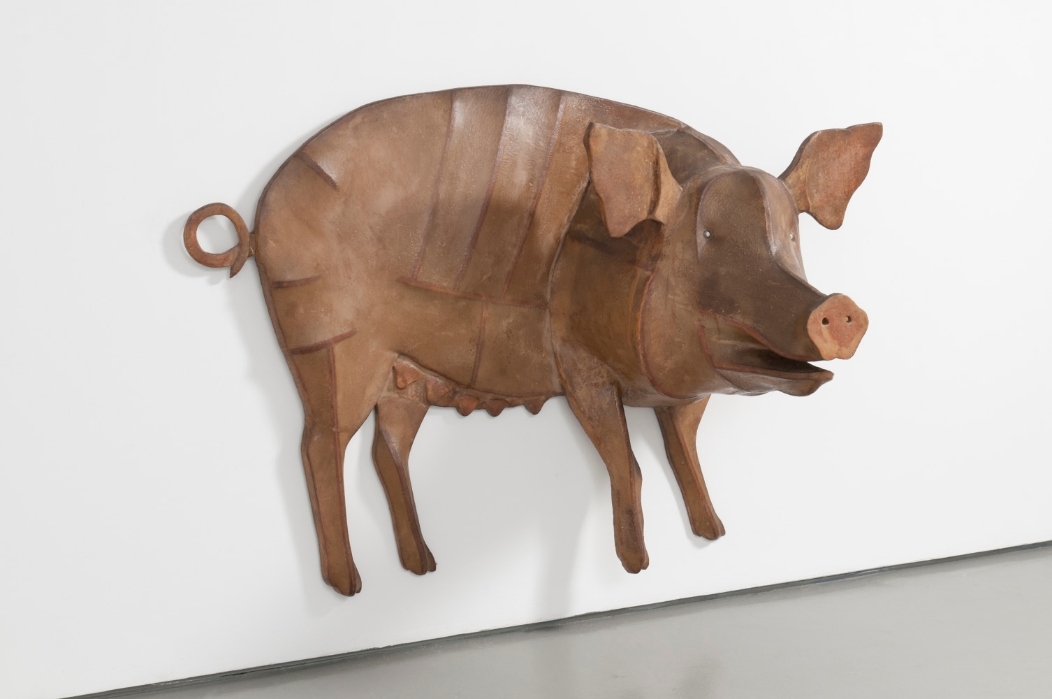 Wall-hanging sculpture of a pig