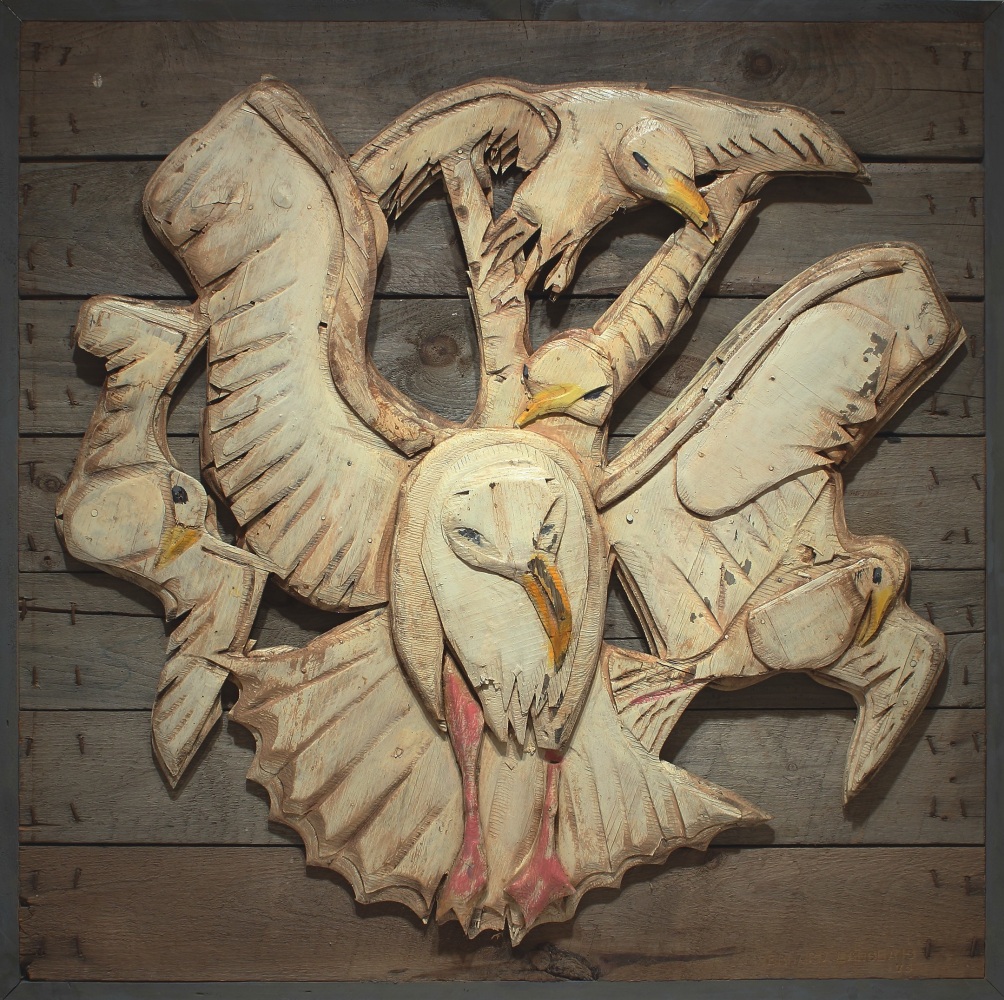 Wooden of five white gulls in flight attached to a wooden background