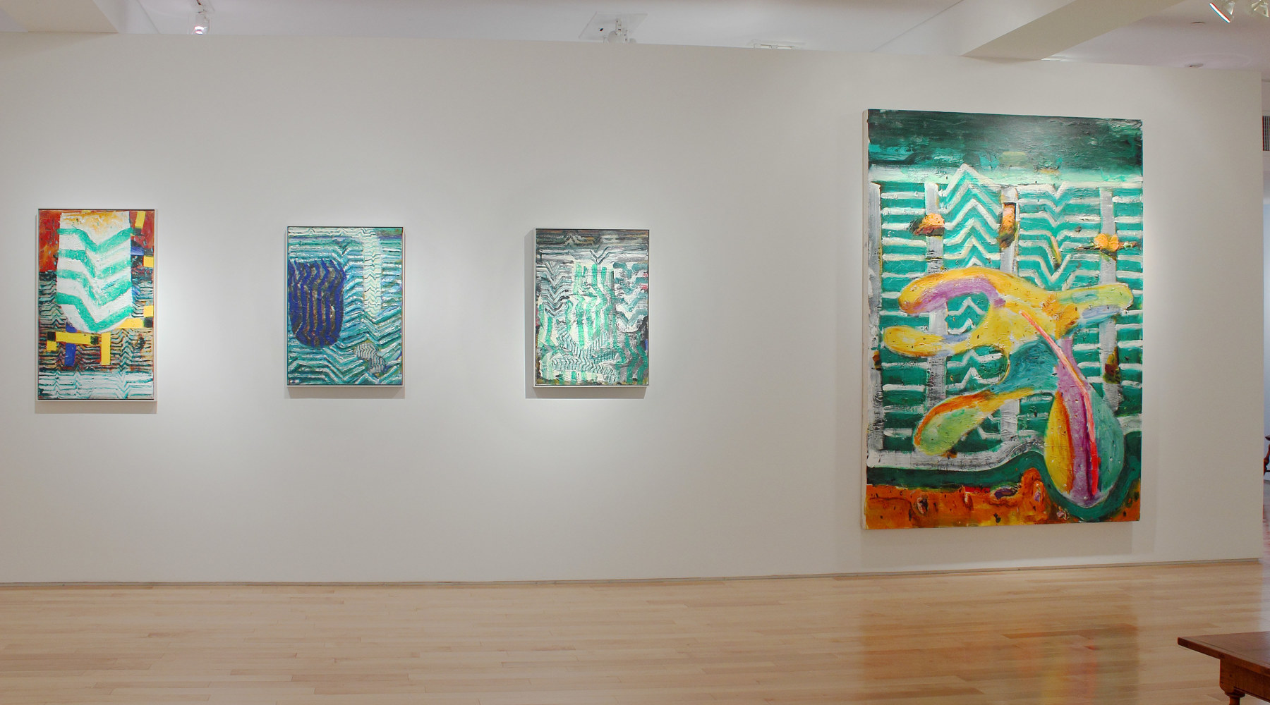 Photograph showing a view of an exhibition space, with one large painting and three smaller paintings hanging on a white wall
