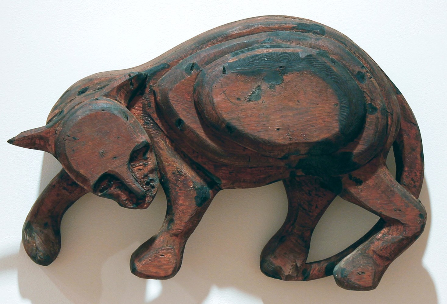Wall-hanging wood sculpture of a cat