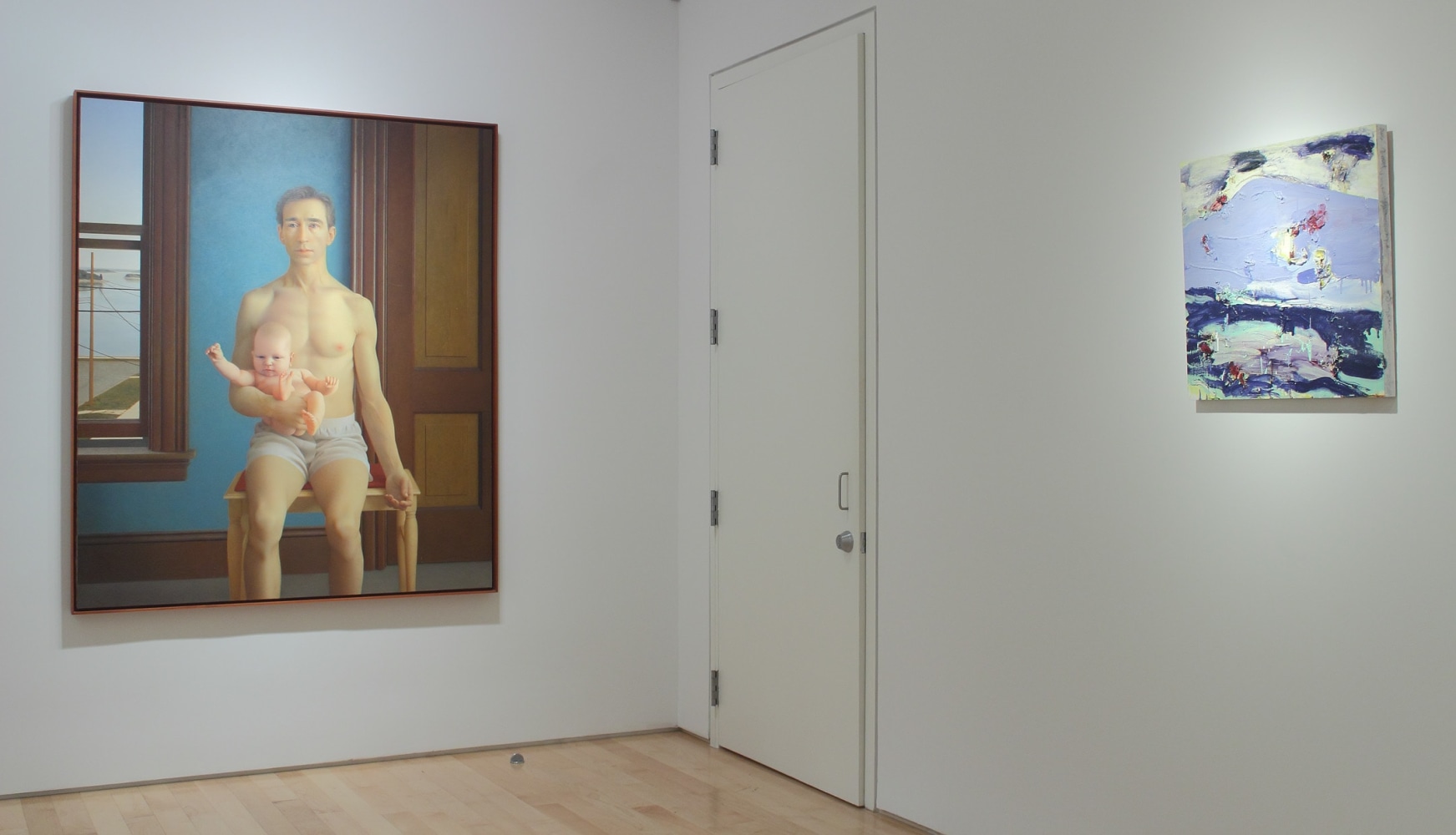 Photograph showing a corner view of an exhibition space, with one large painting and one smaller painting hanging on white walls