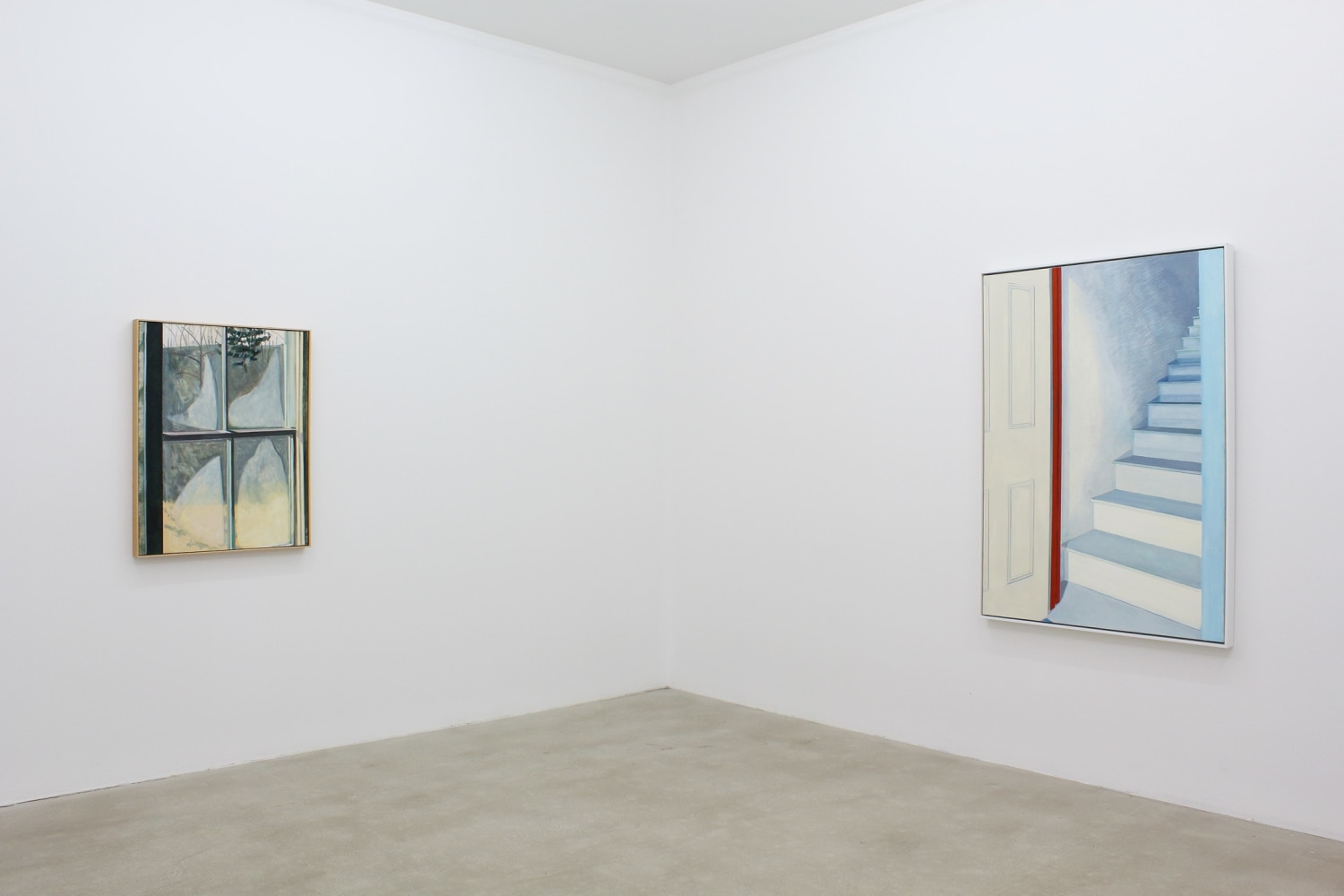 Photograph showing a corner view of an exhibition space, with two paintings hung on white walls