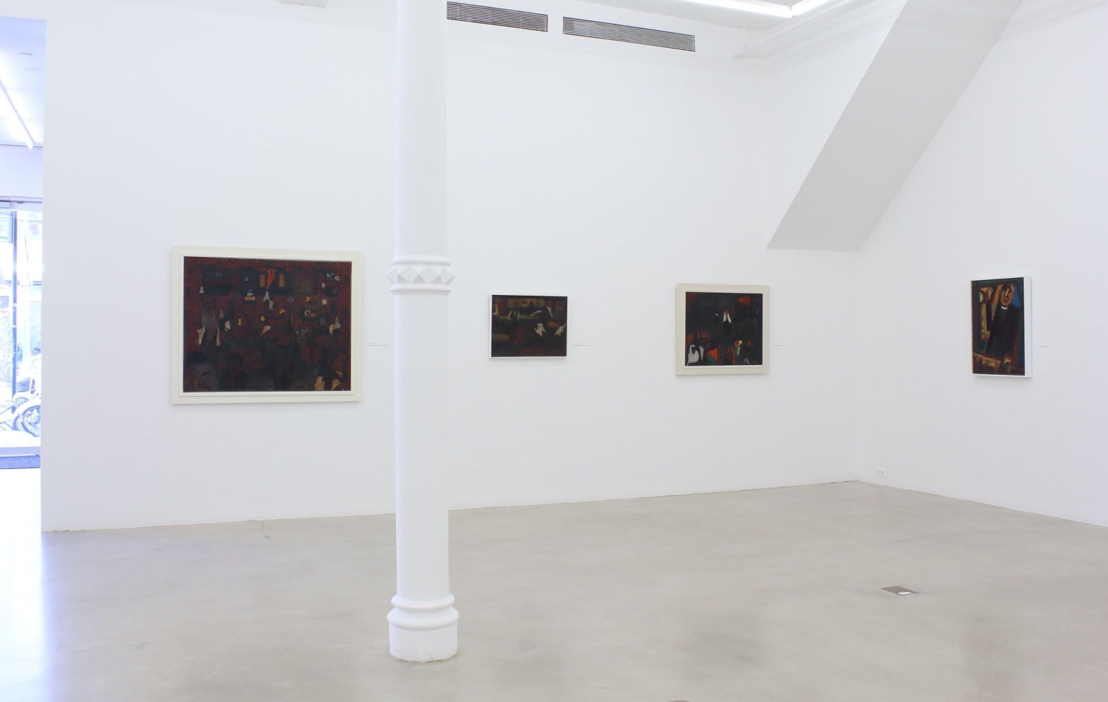 Photograph showing a corner view of an exhibition space, with four paintings hanging on white walls