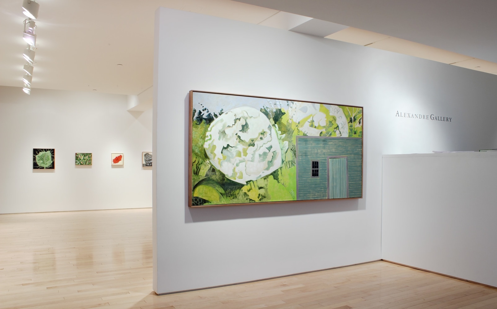 Photograph showing a view of an exhibition space with one large painting hanging on a white wall and the exhibition continuing in the background