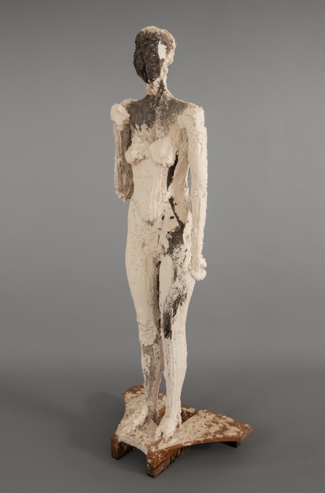 An image of a Manuel Neri sculpture of a Standing Female Figure, made in 1987 from plaster, burlap, acrylic, wood, styrofoam, and steel.  Its dimensions are  70 3/4 x 26 1/4 x 17 1/2 inches.