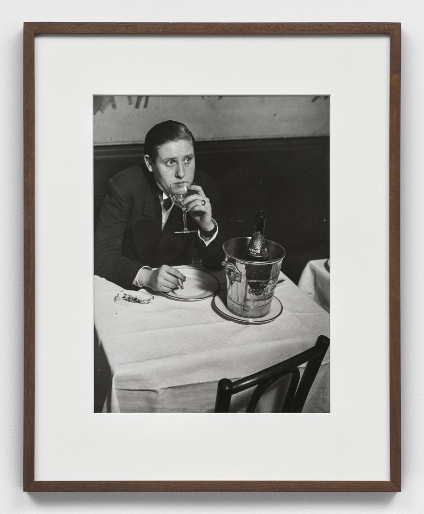 Black and white photographic portrait of woman dressed as a man at Le Monocle, Paris.