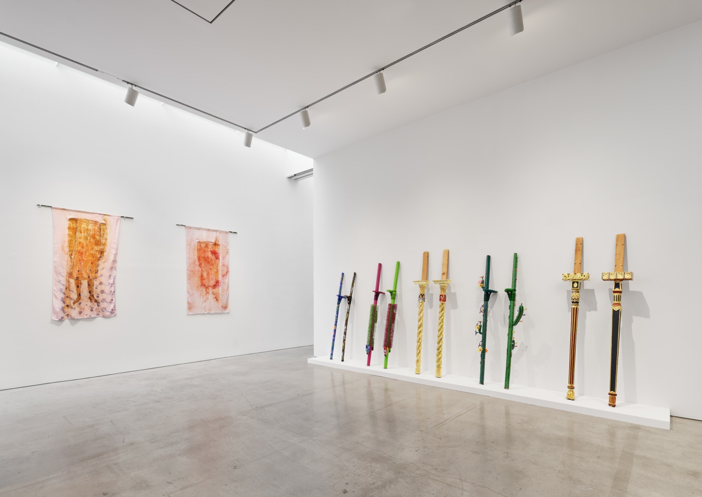 Installation view of &quot;Laura Anderson Barbata: Singing Leaf&quot; showcasing stilts from the artist's performances.