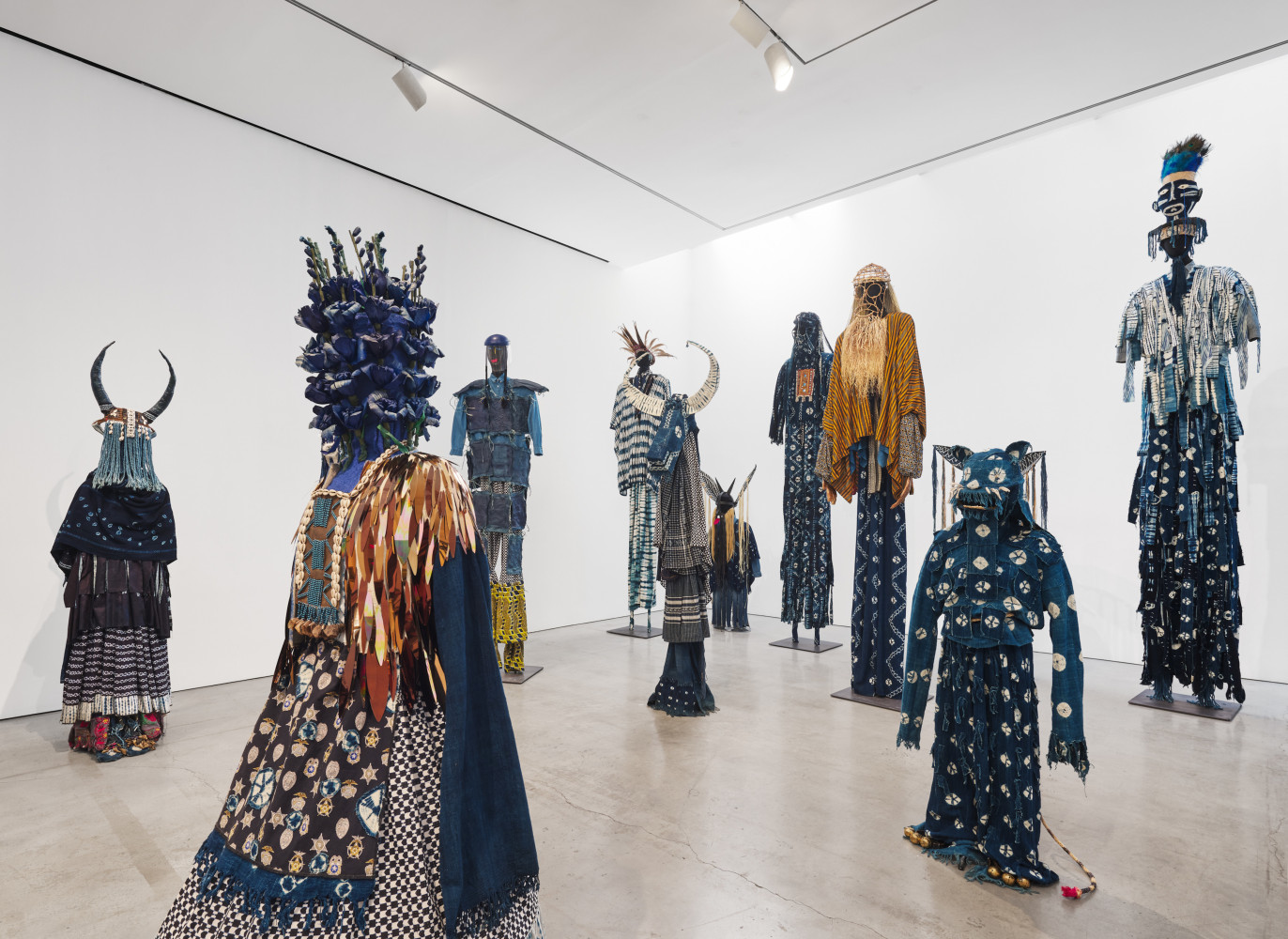 Installation view of &quot;Laura Anderson Barbata: Singing Leaf&quot; showcasing the 'Intervention Indigo' costumes.