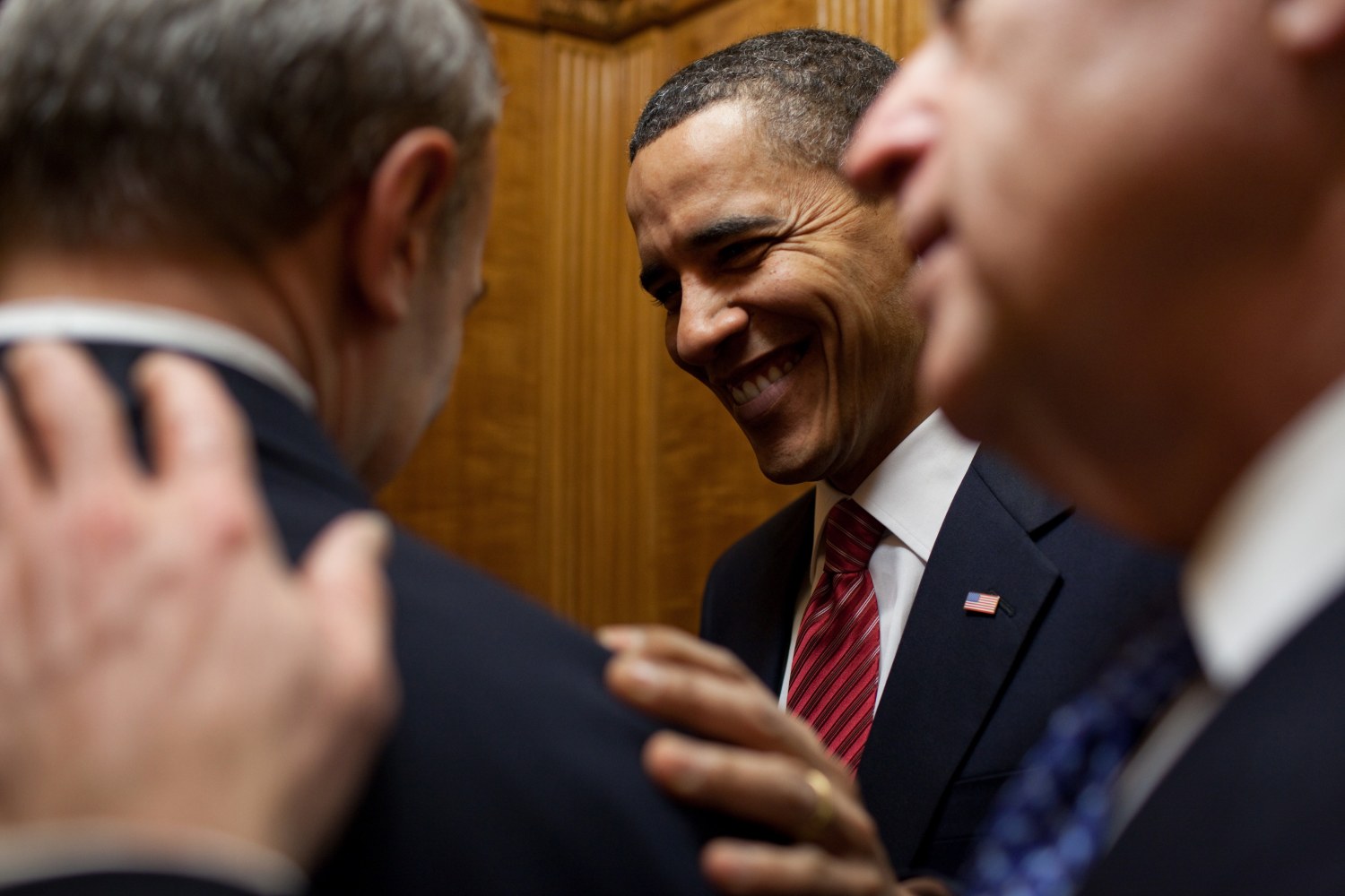 President Obama and Vice President Biden congratulate Phil Schiliro, Assistant to the President for Legislative Affairs, on the passage of the health care reform bill, White House, March 21, 2010 (Courtesy Barack Obama Presidential Library)