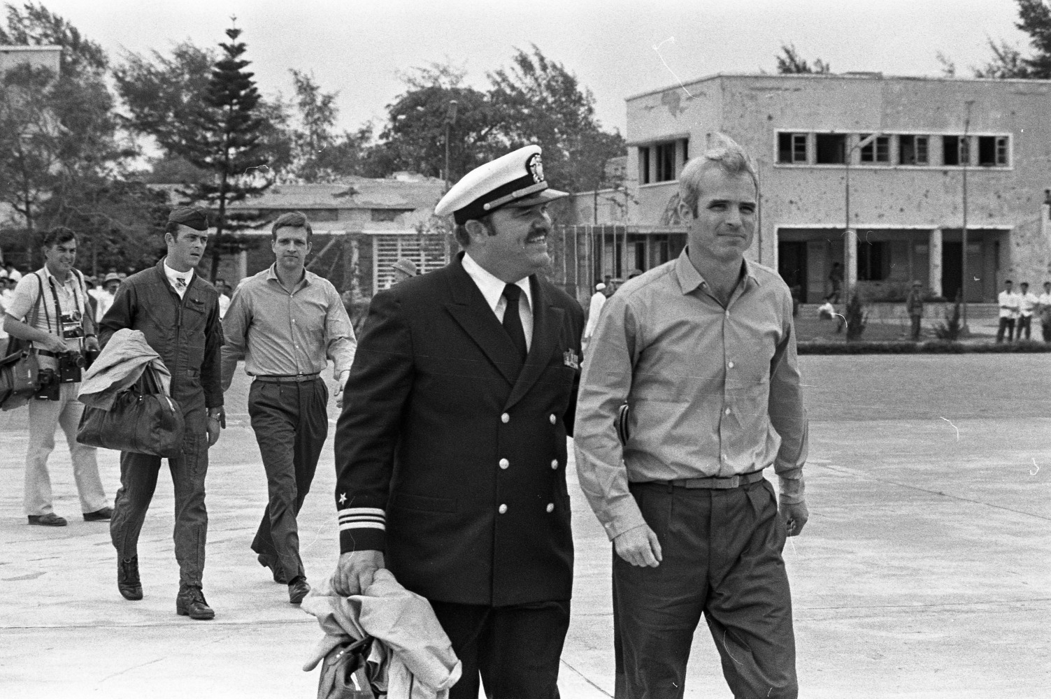 Lt. Commander John McCain escorted to a waiting Air Force aircraft at Gia Lam Airport after his release from prison in Hanoi, Vietnam, March 14, 1973 (U.S. Air Force photo by Tech. Sgt. James L. Baker, Courtesy Images of Freedom)