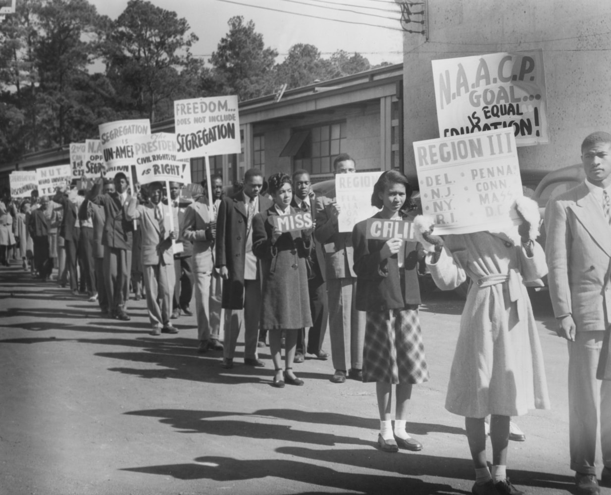 NAACP youth and student members marching with signs protesting Texas segregation laws, Houston, Texas, 1947