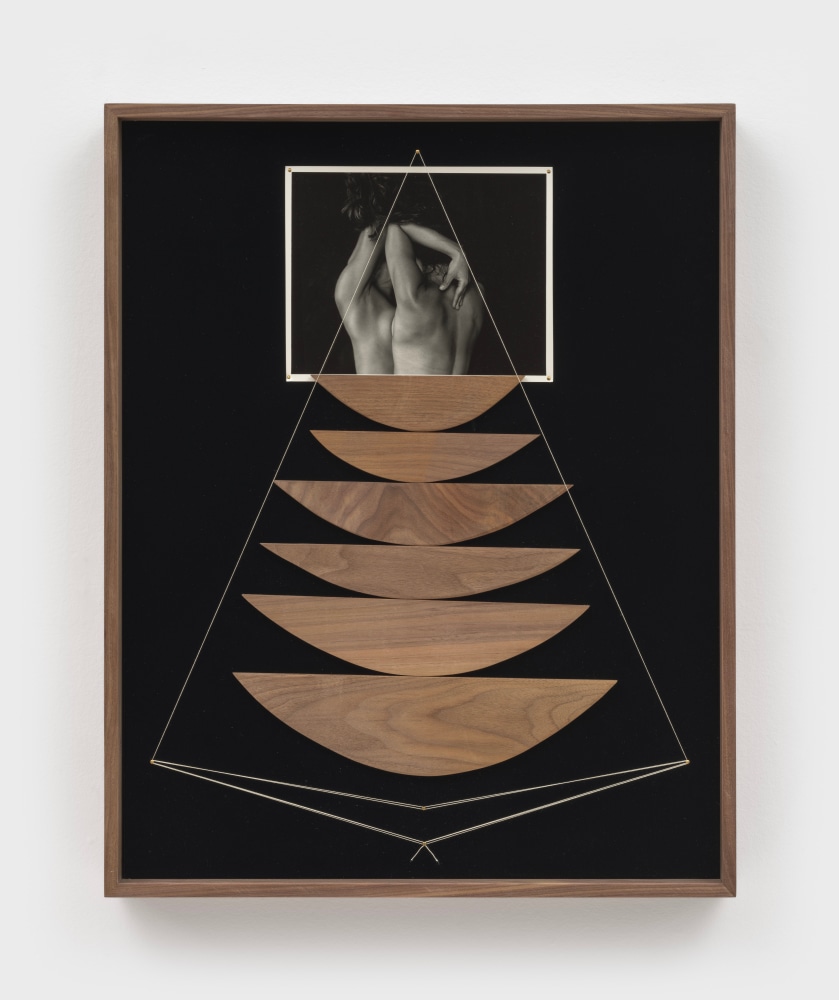 A framed collage of wood and string and a black and white photo of a naked torso pressed against a mirror.