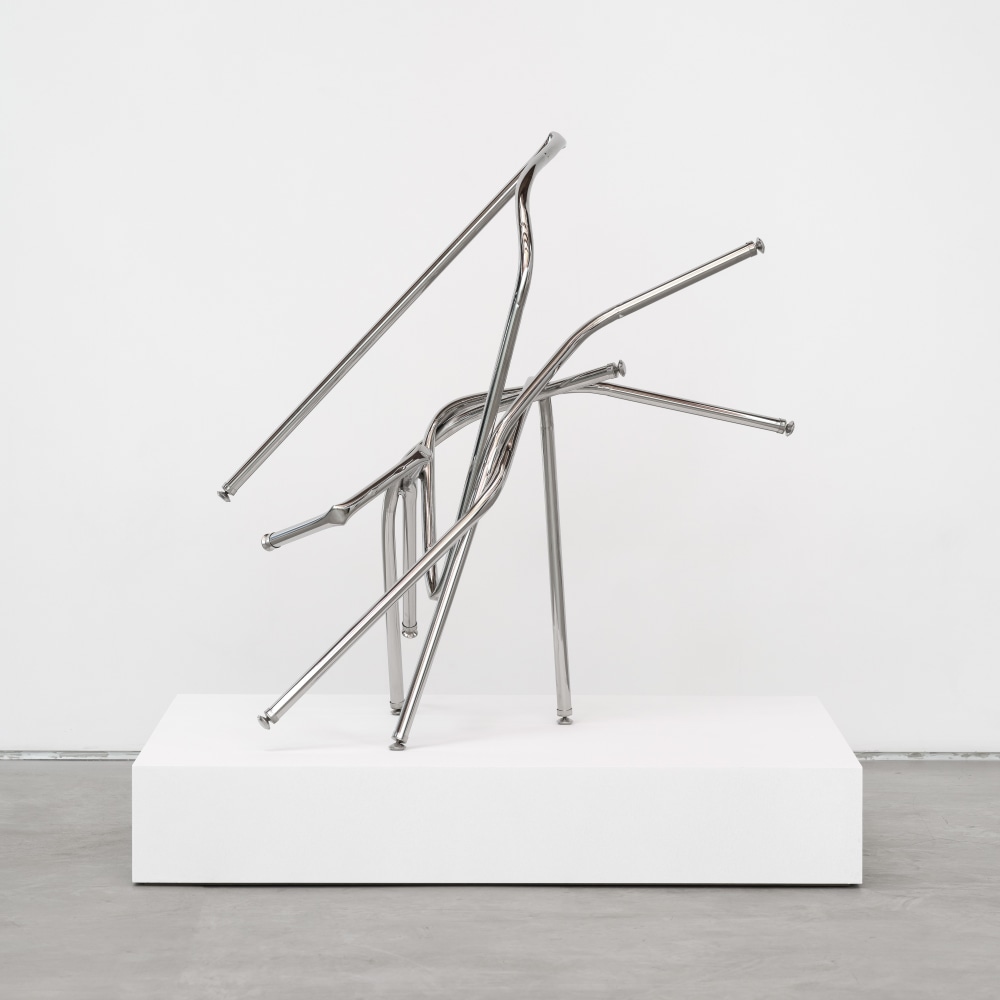 A freestanding sculpture by Josh Callaghan of entangled steel tubing extending diagonally.
