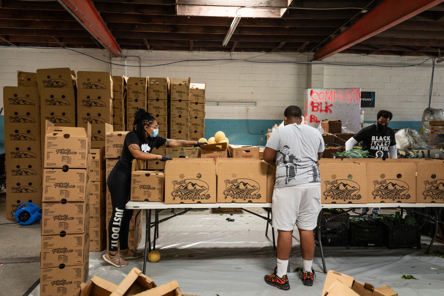 (Left to right) Krystal Grasso, Louis Taylor, and Breonte Davis assemble&amp;nbsp;boxes to deliver to communities in Watts and South Central LA