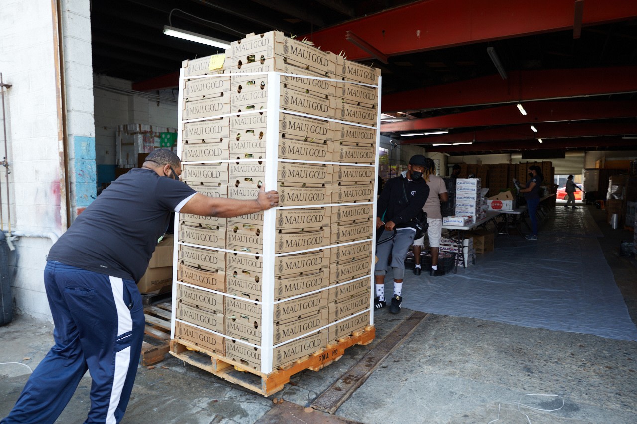 Chris Brown and Breonte Davis bring crates into Summaeverythang Community Center