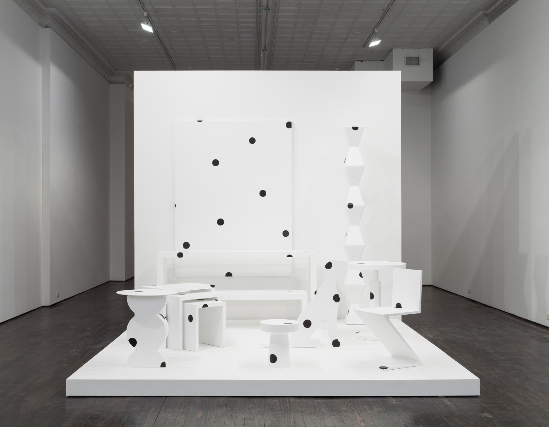 Abstract white furniture covered in black polka dots