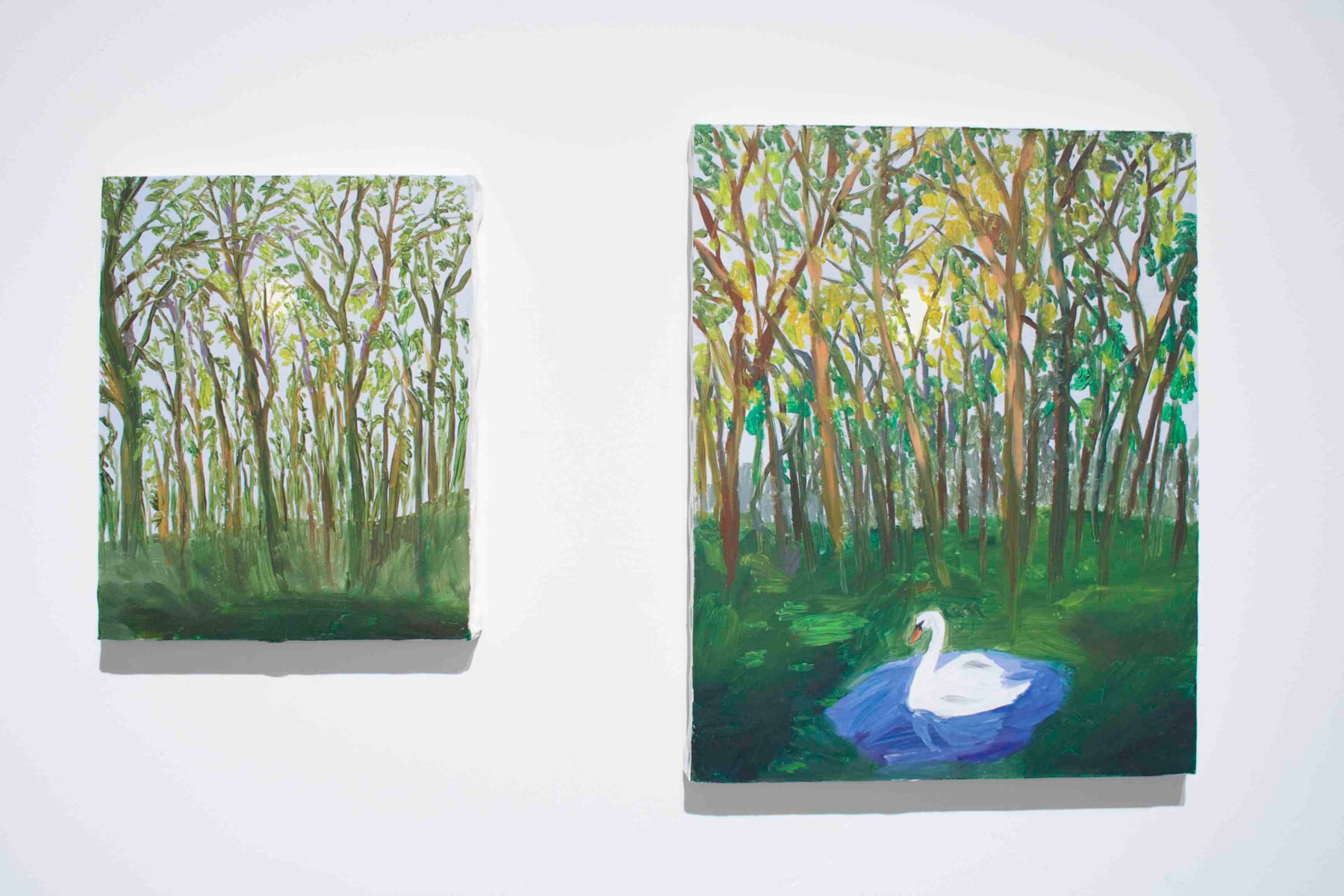 two paintings featuring woods, one with swan